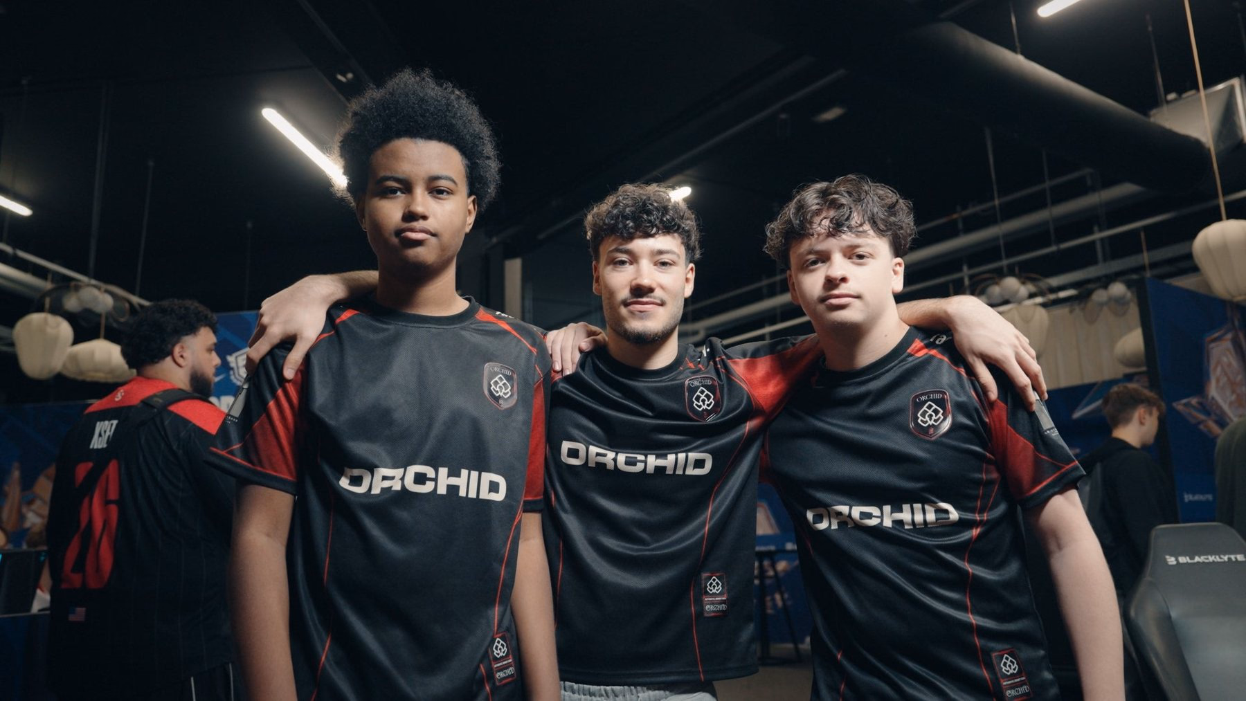 Orchid’s three Fortnite players pose arm in arm in club jerseys.